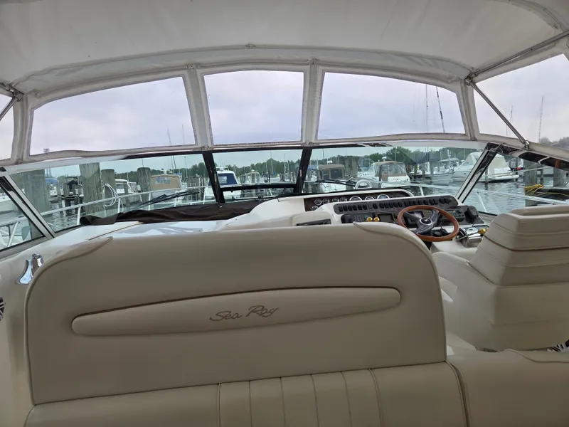 Slide: The Image of 1998 Sea Ray 400 Sundancer yacht interior with helm, docked at marina. - 17
