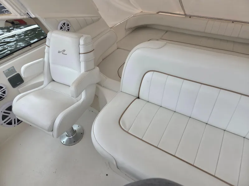 Slide: The Image of 1998 Sea Ray 400 Sundancer interior with white leather seating and captain's chair. - 19