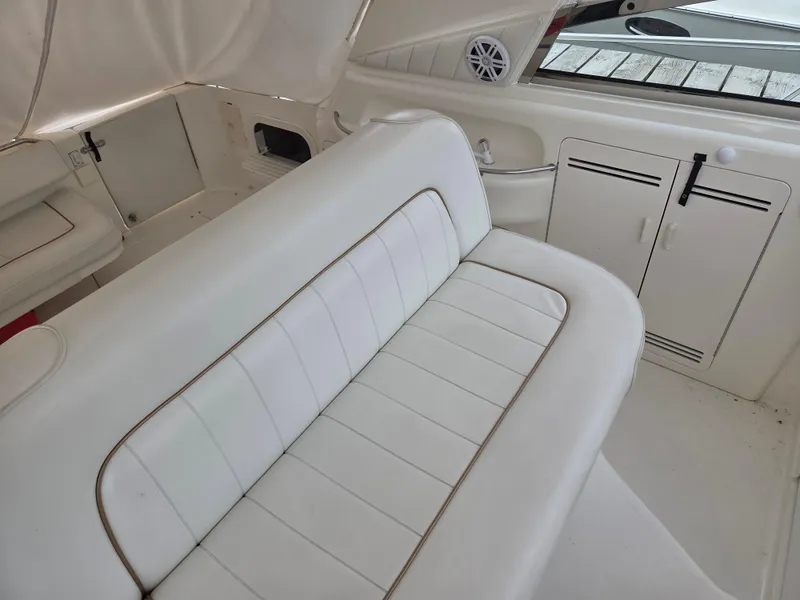 Slide: The Image of Interior of 1998 Sea Ray 400 Sundancer with white seating and storage cabinets. - 20