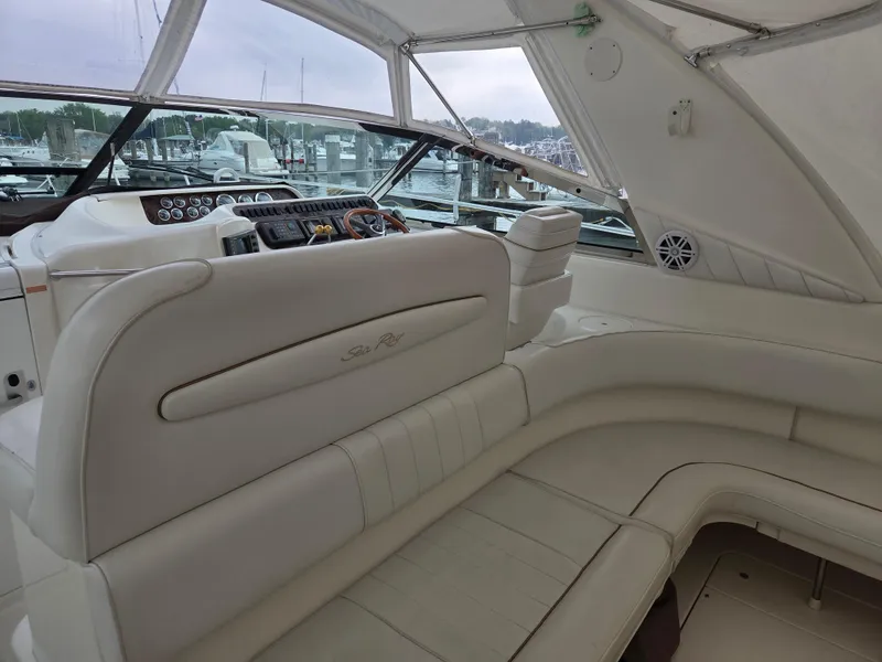 Slide: The Image of 1998 Sea Ray 400 Sundancer interior with white leather seating and helm controls. - 21