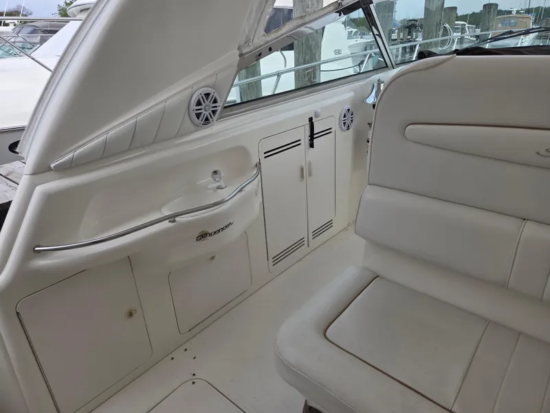 Slide: The Image of 1998 Sea Ray 400 Sundancer interior with white seating and cabinetry. - 22