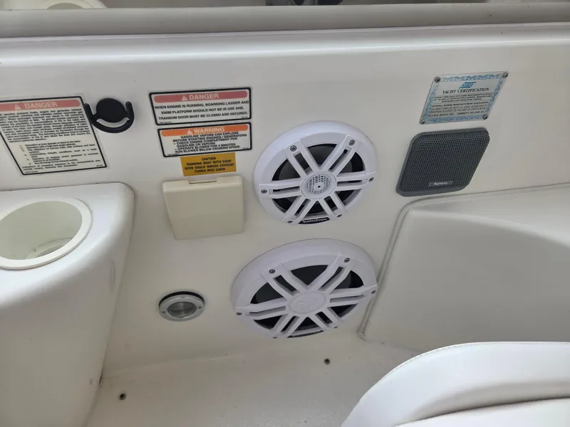 Slide: The Image of 1998 Sea Ray 400 Sundancer boat interior with speakers and safety labels. - 23