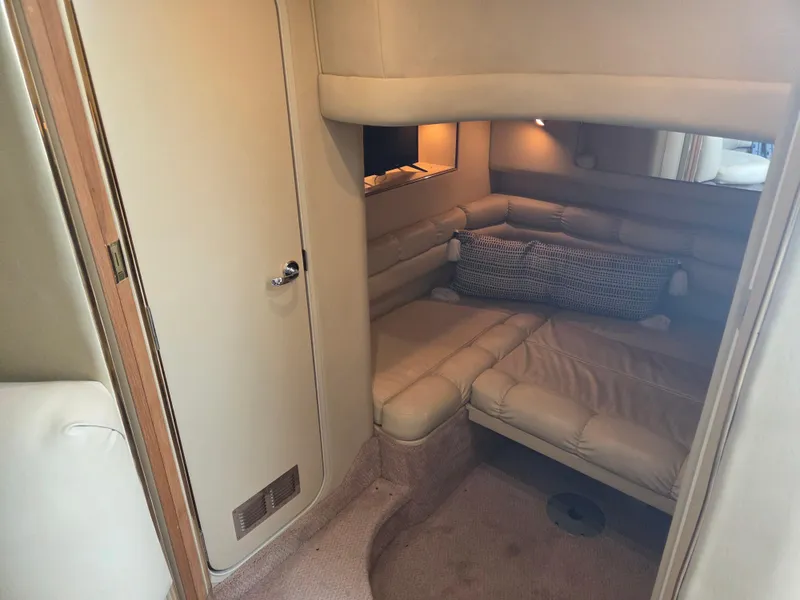 Slide: The Image of 1998 Sea Ray 400 Sundancer cabin interior with beige seating and cozy lighting. - 29