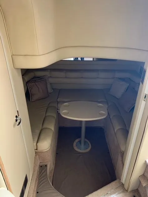 Slide: The Image of 1997 Sea Ray 400 Sundancer cabin interior with seating and table. - 31