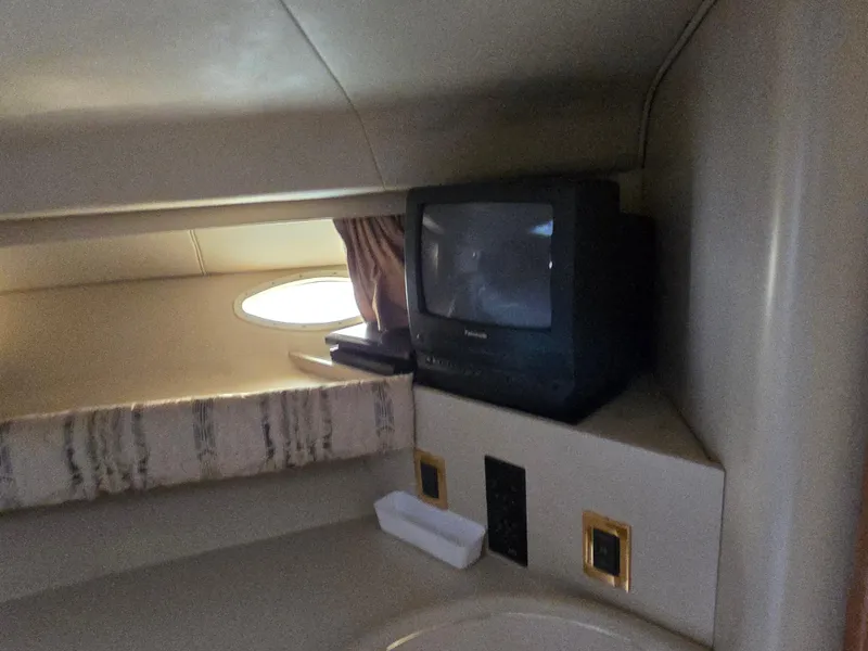 Slide: The Image of 1998 Sea Ray 400 Sundancer cabin with vintage TV and porthole window. - 33