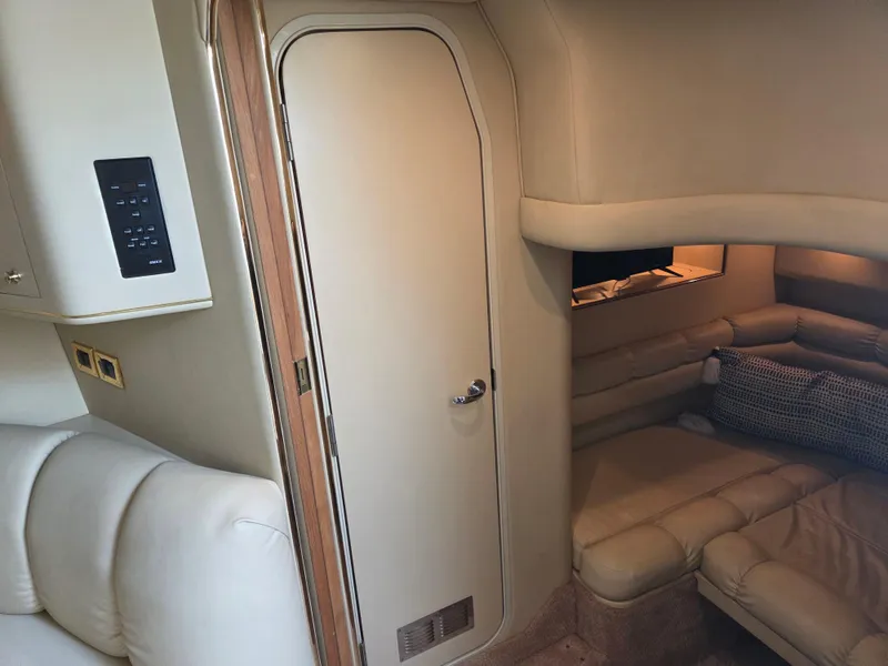 Slide: The Image of Interior of 1998 Sea Ray 400 Sundancer yacht with beige seating and door. - 35