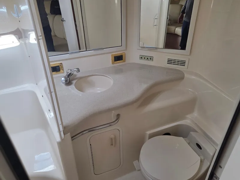 Slide: The Image of 1998 Sea Ray 400 Sundancer bathroom with sink, mirror, and toilet. - 36