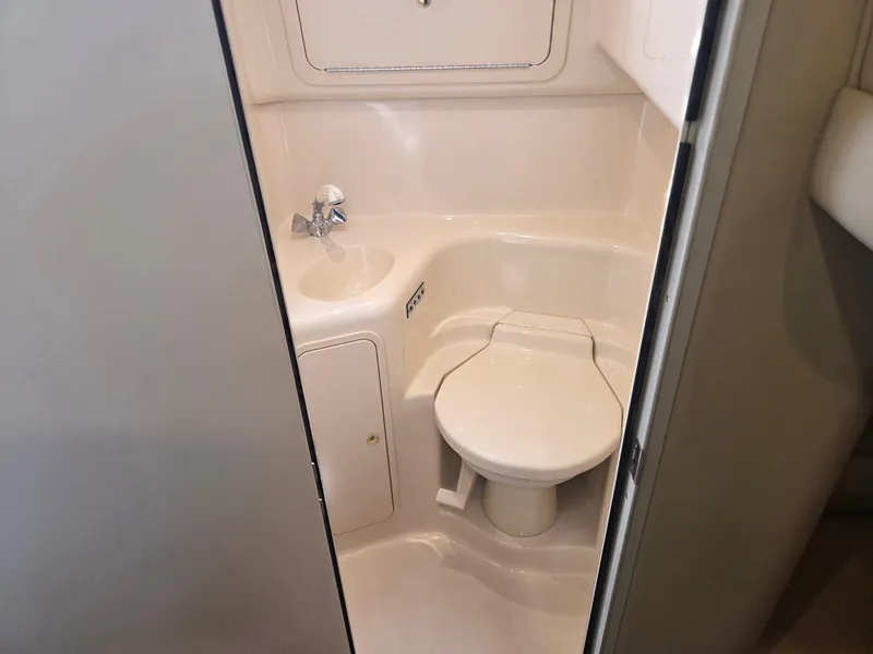 Slide: The Image of 1998 Sea Ray 400 Sundancer bathroom with compact toilet and sink. - 37