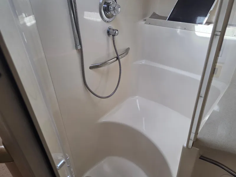 Slide: The Image of Shower area in 1998 Sea Ray 400 Sundancer yacht, featuring modern fixtures and sleek design. - 38
