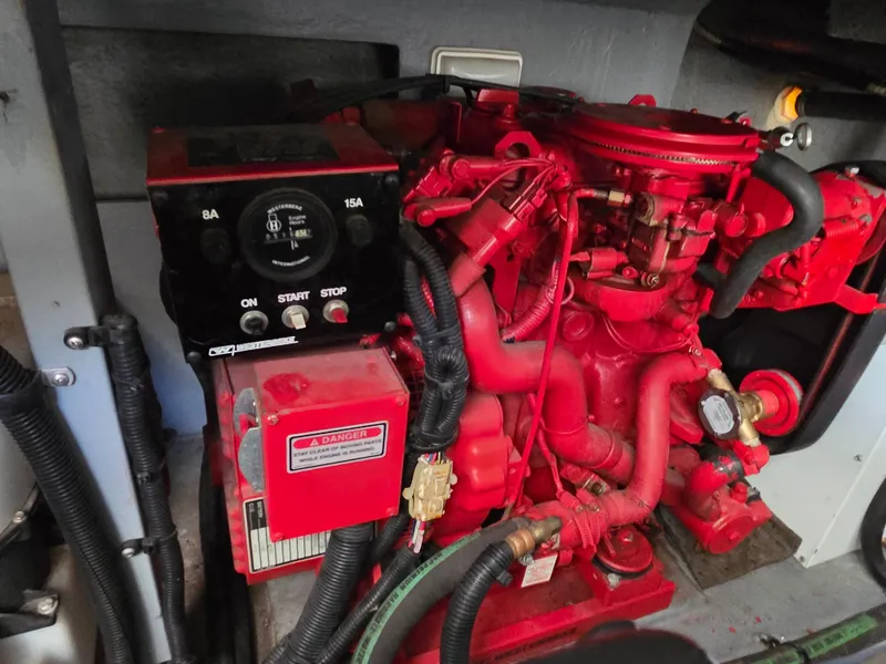 Slide: The Image of Engine compartment of a 1998 Sea Ray 400 Sundancer boat, featuring a red engine. - 41