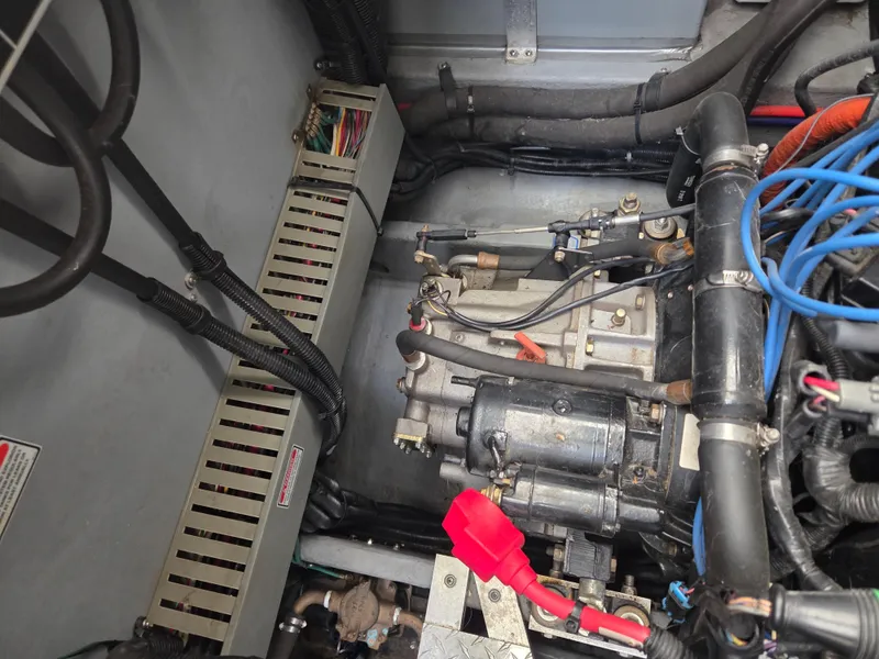 Slide: The Image of Engine compartment of a 1998 Sea Ray 400 Sundancer boat, showing mechanical components and wiring. - 43