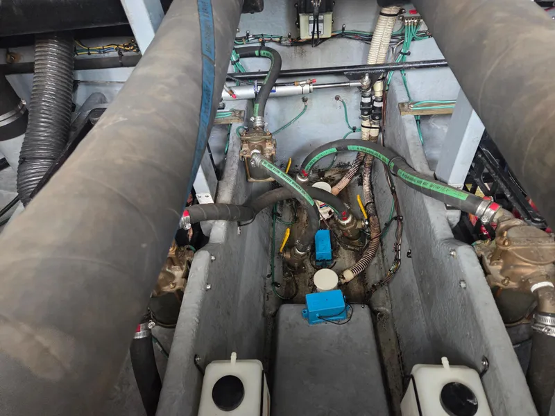 Slide: The Image of Engine compartment of a 1998 Sea Ray 400 Sundancer with visible hoses and components. - 46