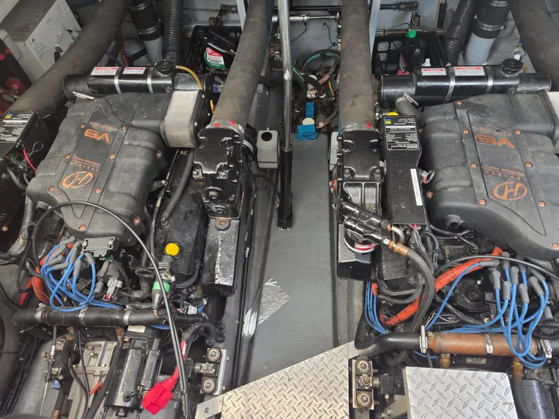 Slide: The Image of Engine room of a 1998 Sea Ray 400 Sundancer with twin engines and visible wiring. - 47