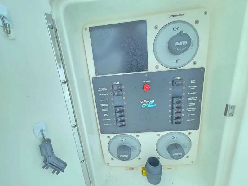 Slide: The Image of Control panel of a 1998 Sea Ray 400 Sundancer boat with switches and dials. - 48
