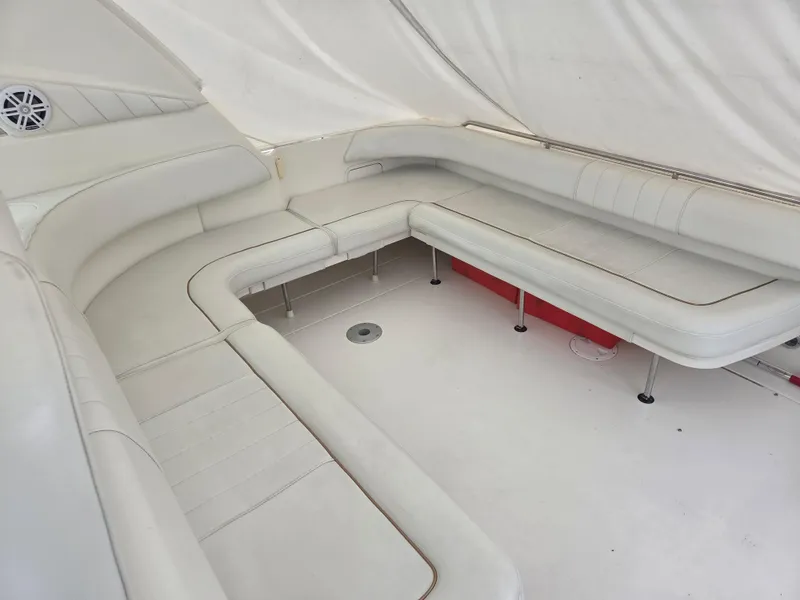 Slide: The Image of 1998 Sea Ray 400 Sundancer interior with white leather seating and sleek design. - 68