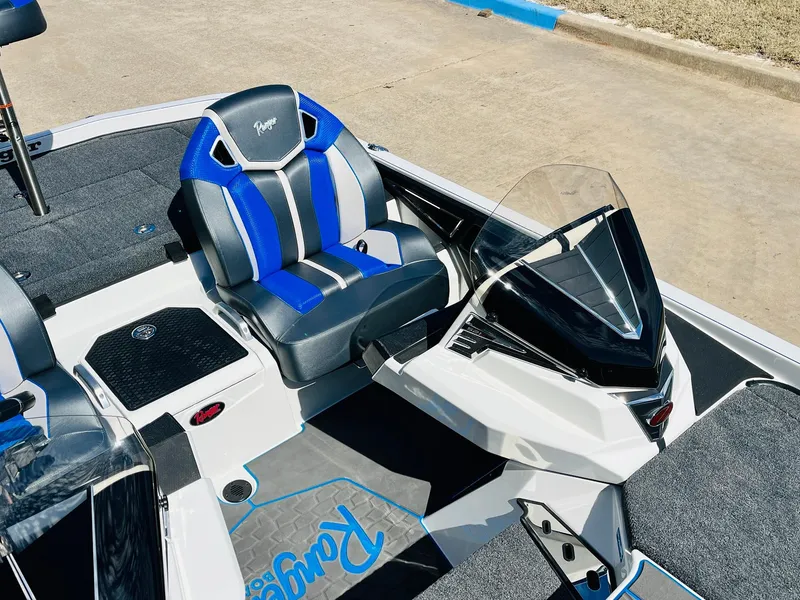 Slide: The Image of 2025 Ranger Z521R Cup-Equipped boat interior with blue and black seating. - 33