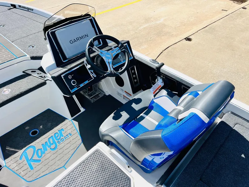 Slide: The Image of 2025 Ranger Z521R Cup-Equipped boat interior with Garmin display and blue seating. - 40
