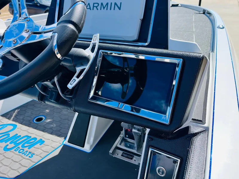 Slide: The Image of 2025 Ranger Z521R Cup-Equipped boat dashboard with Garmin display and steering wheel. - 43