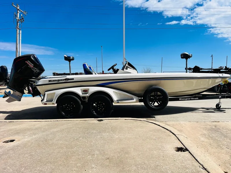Slide: The Image of 2025 Ranger Z521R Cup-Equipped boat, side view, parked on a trailer under a clear blue sky. - 7