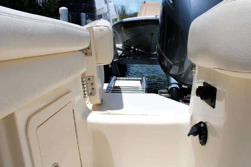 Slide: The Image of 2019 Grady-White Freedom 275 boat interior with ladder and engine view. - 13