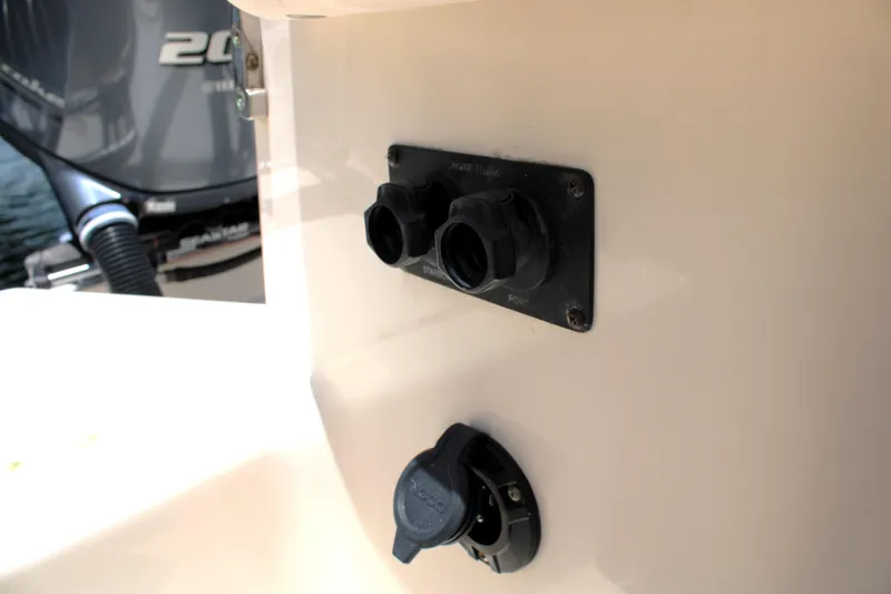 Slide: The Image of 2019 Grady-White Freedom 275 boat electrical panel with connectors and engine in background. - 14