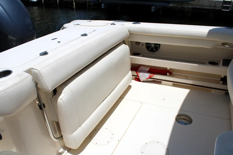 Slide: The Image of 2019 Grady-White Freedom 275 boat interior with white seating and storage area. - 15