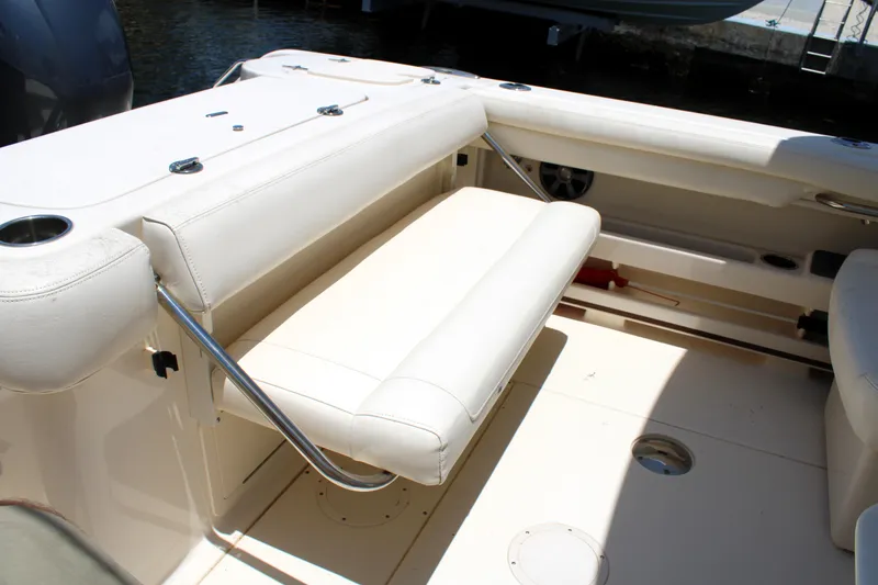 Slide: The Image of 2019 Grady-White Freedom 275 boat interior with beige seating and cup holders. - 16