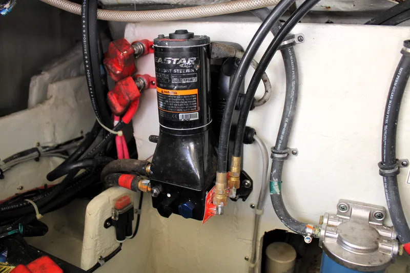 Slide: The Image of Engine compartment of 2019 Grady-White Freedom 275, featuring hydraulic steering components and wiring. - 19