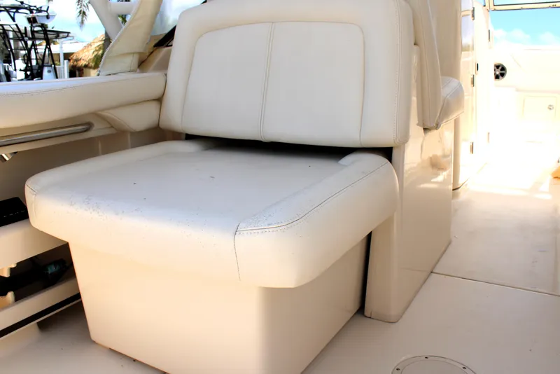 Slide: The Image of 2019 Grady-White Freedom 275 boat interior with white cushioned seating. - 21