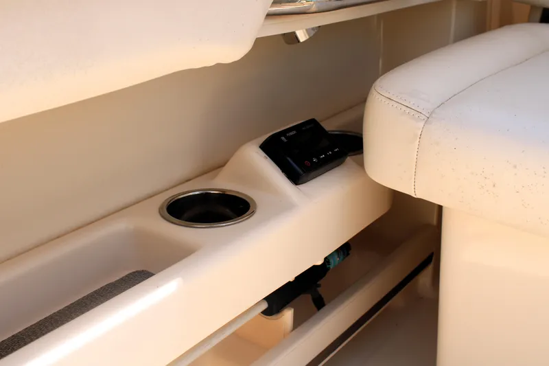Slide: The Image of 2019 Grady-White Freedom 275 boat interior with cup holder and control panel. - 23