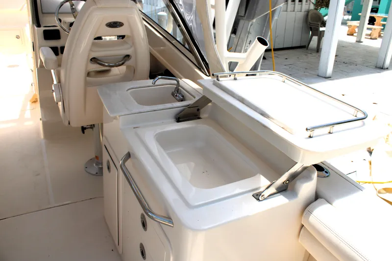 Slide: The Image of 2019 Grady-White Freedom 275 boat interior with dual sinks and seating area. - 26