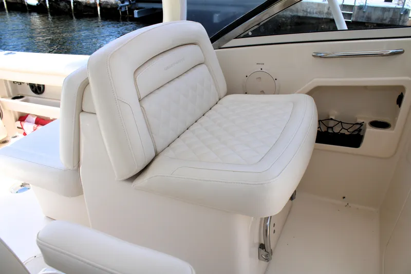 Slide: The Image of 2019 Grady-White Freedom 275 boat interior with white cushioned seating. - 27