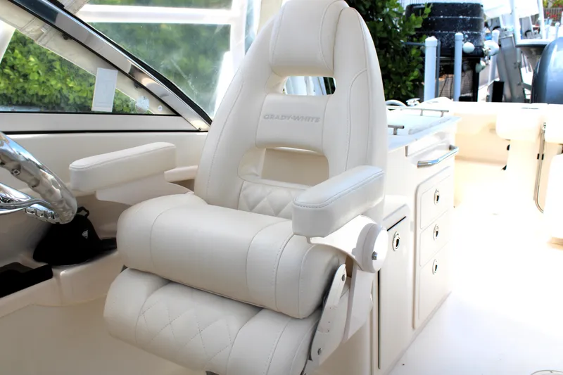Slide: The Image of Captain's chair on 2019 Grady-White Freedom 275 boat, featuring luxurious white upholstery. - 28