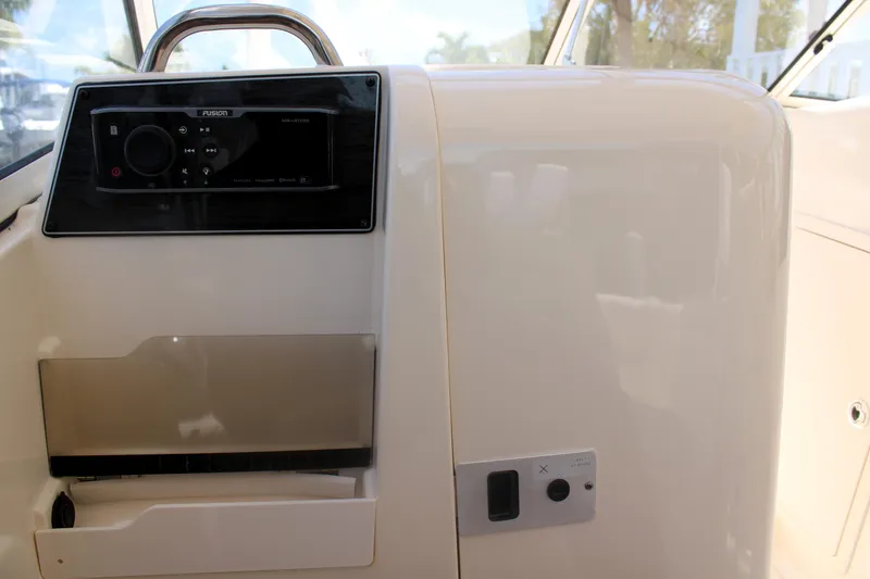 Slide: The Image of 2019 Grady-White Freedom 275 boat interior with control panel and storage compartments. - 30