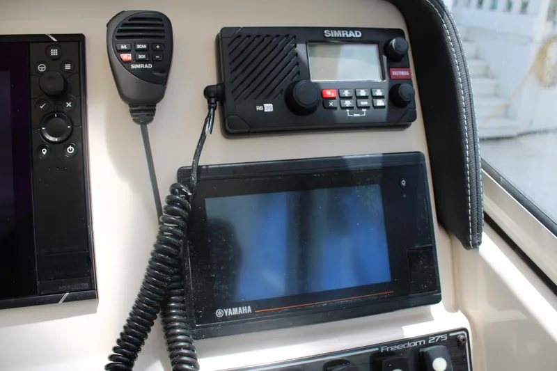 Slide: The Image of 2019 Grady-White Freedom 275 dashboard with Simrad and Yamaha electronics. - 32