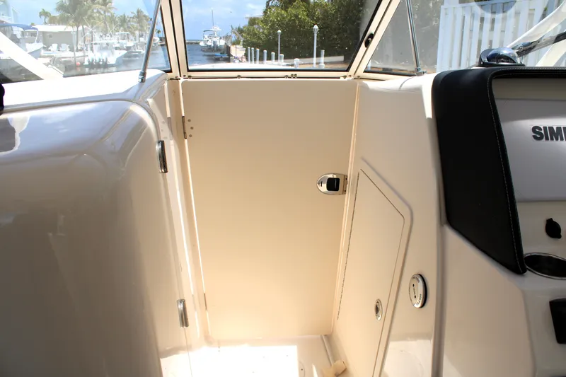 Slide: The Image of 2019 Grady-White Freedom 275 boat interior with door and control panel. - 38