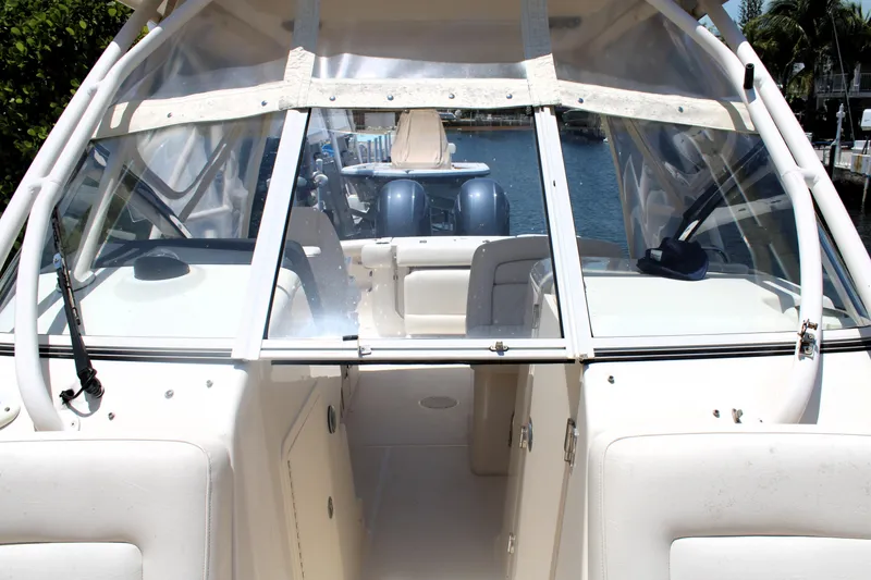Slide: The Image of 2019 Grady-White Freedom 275 boat interior with clear windshield and seating. - 39