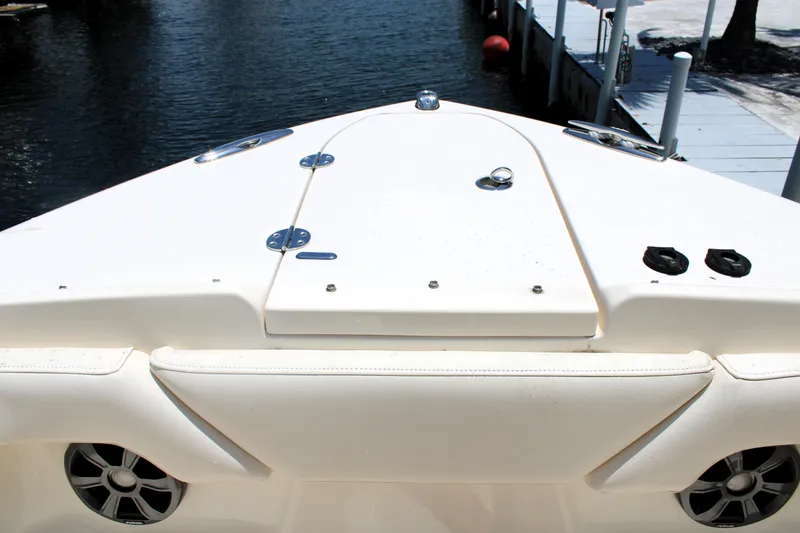 Slide: The Image of 2019 Grady-White Freedom 275 boat bow with speakers and hatch, docked by water. - 42