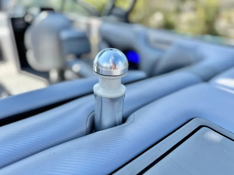 Slide: The Image of 2021 Moomba Craz interior detail with metallic knob on textured surface. - 10