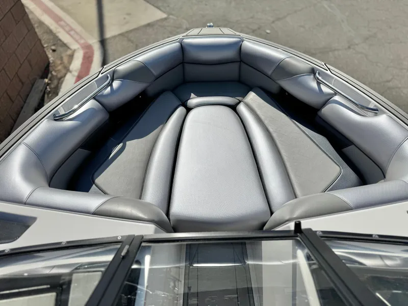 Slide: The Image of 2021 Moomba Craz boat interior with gray cushioned seating in the bow area. - 15