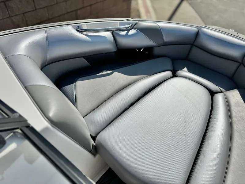 Slide: The Image of 2021 Moomba Craz boat interior with gray cushioned seating. - 16