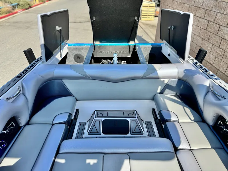Slide: The Image of 2021 Moomba Craz boat interior with open storage compartments and cushioned seating. - 20