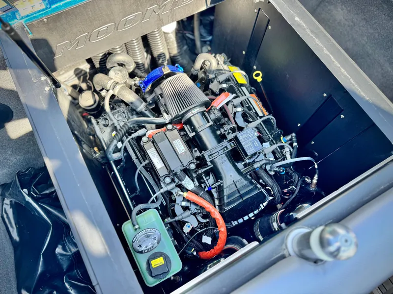Slide: The Image of Engine compartment of a 2021 Moomba Craz boat, showcasing detailed mechanical components. - 21