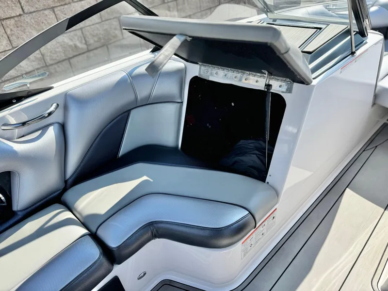 Slide: The Image of 2021 Moomba Craz boat interior with open storage compartment and sleek seating design. - 23
