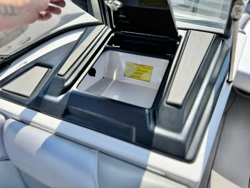 Slide: The Image of 2021 Moomba Craz boat storage compartment with open lid, showcasing interior details. - 24