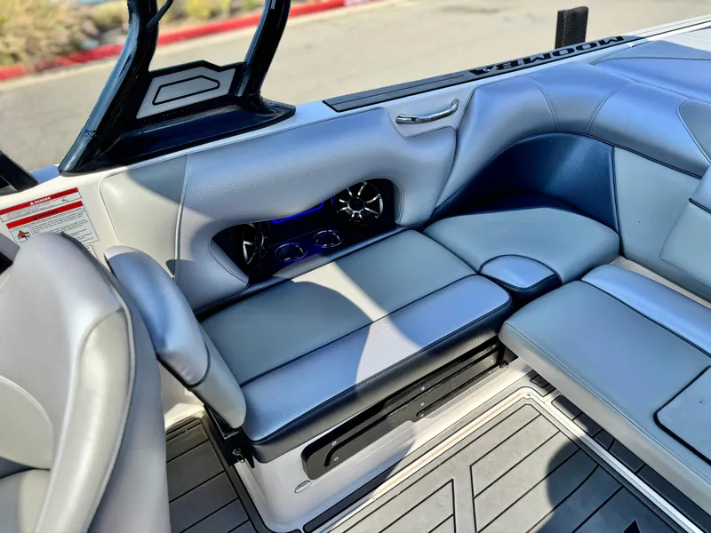 Slide: The Image of 2021 Moomba Craz boat interior with gray seating and built-in speakers. - 25