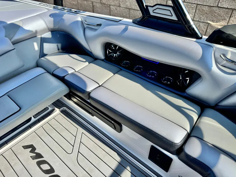 Slide: The Image of 2021 Moomba Craz boat interior with gray seating and built-in speakers. - 27