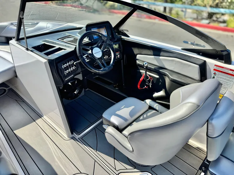 Slide: The Image of 2021 Moomba Craz boat interior with steering wheel and dashboard, featuring modern design elements. - 28