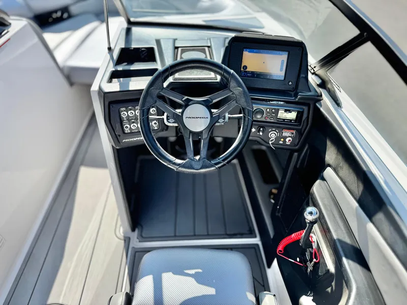 Slide: The Image of 2021 Moomba Craz boat cockpit with steering wheel and control panel. - 29