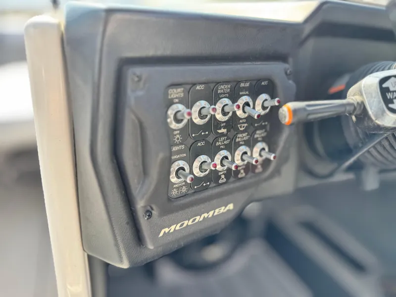 Slide: The Image of Control panel of a 2021 Moomba Craz boat with various switches and labels. - 31